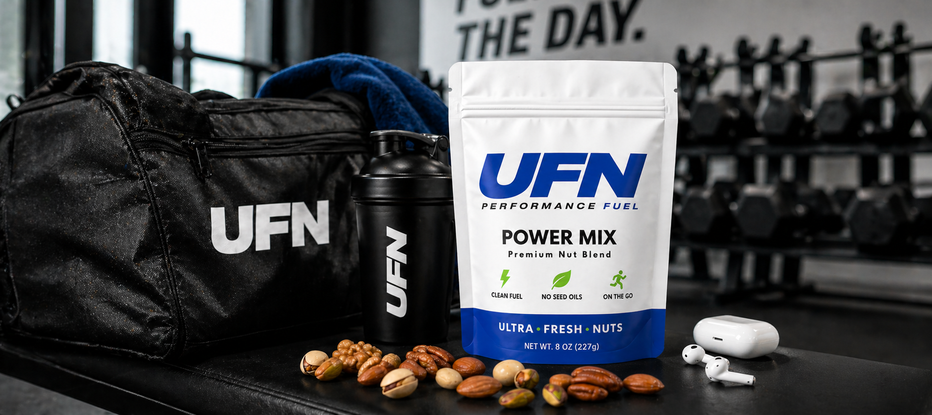 UFN performance mix packaging with a bag, shaker, and nuts on a gym bench.